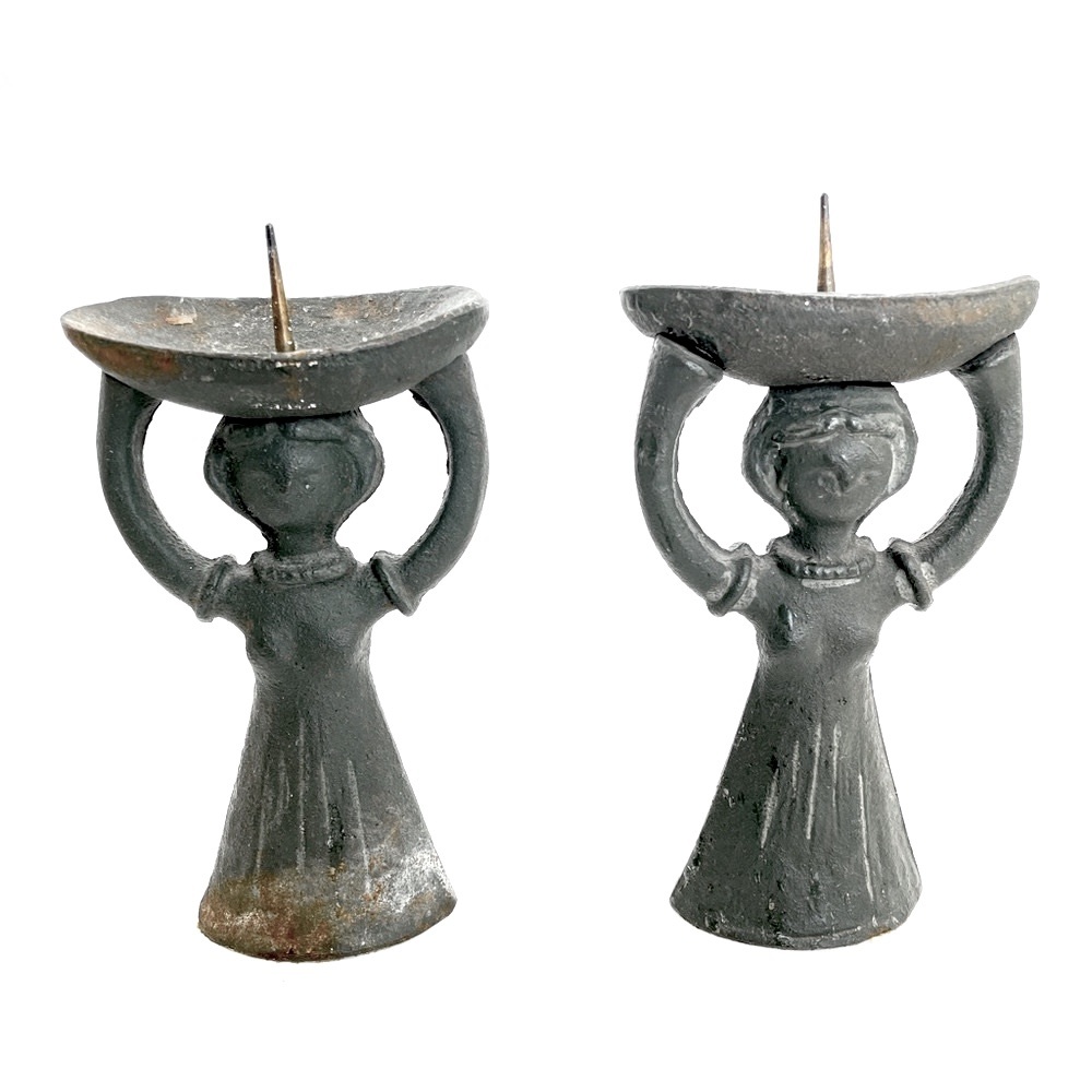 A pair of antique “Corn Women” bronze sculptural candlestick holders.
